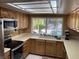 Bright kitchen area with stainless steel appliances, tiled countertops, and natural light at 5821 Santa Catalina Ave, Las Vegas, NV 89108