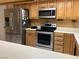 Charming kitchen with stainless steel appliances and tiled backsplash, offering a clean aesthetic at 5821 Santa Catalina Ave, Las Vegas, NV 89108