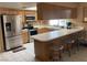 Well-lit kitchen featuring stainless steel appliances, a breakfast bar, and ample counter space at 5821 Santa Catalina Ave, Las Vegas, NV 89108