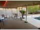 Covered patio with furniture, a potted palm and a view of the sparkling pool at 5821 Santa Catalina Ave, Las Vegas, NV 89108