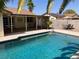 Inviting pool with covered patio, surrounded by a brick wall and patio furniture at 5821 Santa Catalina Ave, Las Vegas, NV 89108