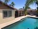 Refreshing in-ground pool with poolside patio, palm trees, and a covered patio at 5821 Santa Catalina Ave, Las Vegas, NV 89108