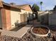 Home exterior featuring decorative gates with stone landscaping, brick accents, and mature trees at 5821 Santa Catalina Ave, Las Vegas, NV 89108