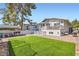 Expansive backyard featuring lush artificial turf, an outdoor kitchen, and a covered patio at 615 D Ave, Boulder City, NV 89005