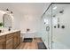 Bright bathroom featuring a clawfoot tub, glass shower with dual shower heads, and stylish vanity at 615 D Ave, Boulder City, NV 89005