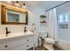 Bright bathroom featuring a dual sink vanity, and a shower/tub combo with tiled walls at 615 D Ave, Boulder City, NV 89005