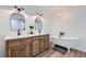 Modern bathroom featuring dual sinks, a vintage style soaking tub and wooden cabinets at 615 D Ave, Boulder City, NV 89005