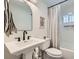 Charming bathroom featuring a pedestal sink, neutral decor, and tiled shower-tub combination at 615 D Ave, Boulder City, NV 89005