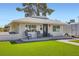 Inviting single-story home with a well-manicured lawn, front porch, and charming curb appeal at 615 D Ave, Boulder City, NV 89005