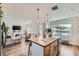 Open concept kitchen with eat-in island, wood floors and adjacent living room at 615 D Ave, Boulder City, NV 89005