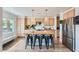 Spacious kitchen with island featuring barstool seating, stylish pendant lighting, and stainless steel refrigerator at 615 D Ave, Boulder City, NV 89005