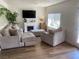 Cozy living room featuring a comfortable sectional sofa, fireplace, and natural light at 615 D Ave, Boulder City, NV 89005