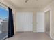 Bedroom featuring light wood floors, ceiling fan, black out curtains, and balcony access at 6217 Lapilli Ave, Las Vegas, NV 89139
