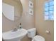 Stylish half-bathroom with a round mirror, patterned window and modern fixtures at 6217 Lapilli Ave, Las Vegas, NV 89139