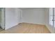 This bedroom offers neutral walls, plank flooring, ensuite bath, and large window at 6800 E Lake Mead Blvd # 1034, Las Vegas, NV 89156