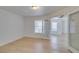 Bright bedroom with light wood floors, white walls, and glass French doors to the living area at 6800 E Lake Mead Blvd # 1034, Las Vegas, NV 89156