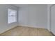 This bedroom offers neutral walls, plank flooring, and large window at 6800 E Lake Mead Blvd # 1034, Las Vegas, NV 89156