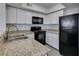 Updated kitchen featuring granite countertops, stainless steel sink and black appliances at 6800 E Lake Mead Blvd # 1034, Las Vegas, NV 89156