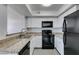 Updated kitchen featuring granite countertops, stainless steel sink and black appliances at 6800 E Lake Mead Blvd # 1034, Las Vegas, NV 89156