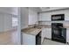 Updated kitchen featuring granite countertops, stainless steel sink and black appliances at 6800 E Lake Mead Blvd # 1034, Las Vegas, NV 89156