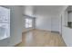 Bright living room with wood-look floors, large window, and neutral paint at 6800 E Lake Mead Blvd # 1034, Las Vegas, NV 89156