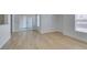 Bright living room features wood-look floors, neutral walls, and sliding glass door to patio at 6800 E Lake Mead Blvd # 1034, Las Vegas, NV 89156