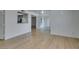 Spacious living area features wood-look floors, pass-through to kitchen, and a bright, neutral color palette at 6800 E Lake Mead Blvd # 1034, Las Vegas, NV 89156