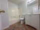 This bathroom features a shower and tub, sink and toilet on patterned tile flooring at 6905 Singing Dunes Ln, Las Vegas, NV 89145