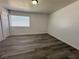 This spacious bedroom offers wood flooring, a window with blinds and neutral paint at 6905 Singing Dunes Ln, Las Vegas, NV 89145