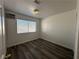 This bedroom features wood flooring, neutral paint, a window and an air conditioning unit at 6905 Singing Dunes Ln, Las Vegas, NV 89145