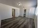 This bedroom features wood floors, neutral paint, closet, window and ample space at 6905 Singing Dunes Ln, Las Vegas, NV 89145