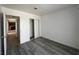This bedroom offers wood flooring, neutral paint, a sliding closet door and ample lighting at 6905 Singing Dunes Ln, Las Vegas, NV 89145