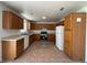 Bright kitchen with wooden cabinets, modern appliances, and tile flooring, offering plenty of storage and workspace at 6905 Singing Dunes Ln, Las Vegas, NV 89145