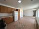 Bright kitchen with wooden cabinets, modern appliances, and tile flooring, with an open layout at 6905 Singing Dunes Ln, Las Vegas, NV 89145