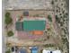 Aerial view of a property showcasing a green roof, an outdoor deck, a shed, and expansive land at 70 Camp Bonanza Rd, Las Vegas, NV 89124