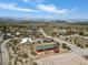 Red home and green roof highlight the landscape, complemented by the natural terrain surrounding the neighborhood at 70 Camp Bonanza Rd, Las Vegas, NV 89124
