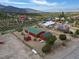 Aerial view shows the red cabin, garage, desert landscape, and surrounding neighborhood at 70 Camp Bonanza Rd, Las Vegas, NV 89124