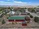 Spacious red home showcasing its green roof, solar panels, and mountain views in a tranquil neighborhood setting at 70 Camp Bonanza Rd, Las Vegas, NV 89124