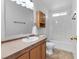 Bathroom with single sink, built in cabinet, shower-tub combo and toilet at 70 Camp Bonanza Rd, Las Vegas, NV 89124