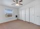 Bedroom with neutral carpet, ceiling fan, window, heater and closets at 70 Camp Bonanza Rd, Las Vegas, NV 89124