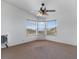 Bedroom showcasing bay windows with natural light and ceiling fan at 70 Camp Bonanza Rd, Las Vegas, NV 89124