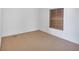 Neutral carpeted bedroom features a window with wood blinds at 70 Camp Bonanza Rd, Las Vegas, NV 89124