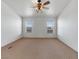 Bedroom with neutral colored walls, carpet flooring, and two large windows at 70 Camp Bonanza Rd, Las Vegas, NV 89124