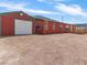 Exterior log home with garage, gravel yard and mountain views at 70 Camp Bonanza Rd, Las Vegas, NV 89124