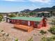 Charming red home featuring a spacious wood deck, offering an ideal space for outdoor entertaining and relaxation at 70 Camp Bonanza Rd, Las Vegas, NV 89124