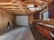 Unfinished garage with storage cabinets, workbench, and exposed beams at 70 Camp Bonanza Rd, Las Vegas, NV 89124