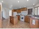 Traditional kitchen features wood cabinets, center island, and tile floors at 70 Camp Bonanza Rd, Las Vegas, NV 89124