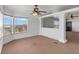 Spacious living room featuring lots of natural light and neutral carpeting at 70 Camp Bonanza Rd, Las Vegas, NV 89124