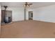 Spacious living room featuring a ceiling fan and a wood burning fireplace at 70 Camp Bonanza Rd, Las Vegas, NV 89124