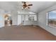 Spacious living room with archway to kitchen and exterior balcony view at 70 Camp Bonanza Rd, Las Vegas, NV 89124
